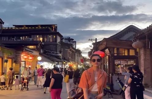 Lantern-lit hutong street busy in the evening