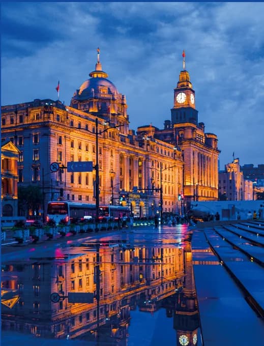 The Bund waterfront lit up and reflected in wet paving
